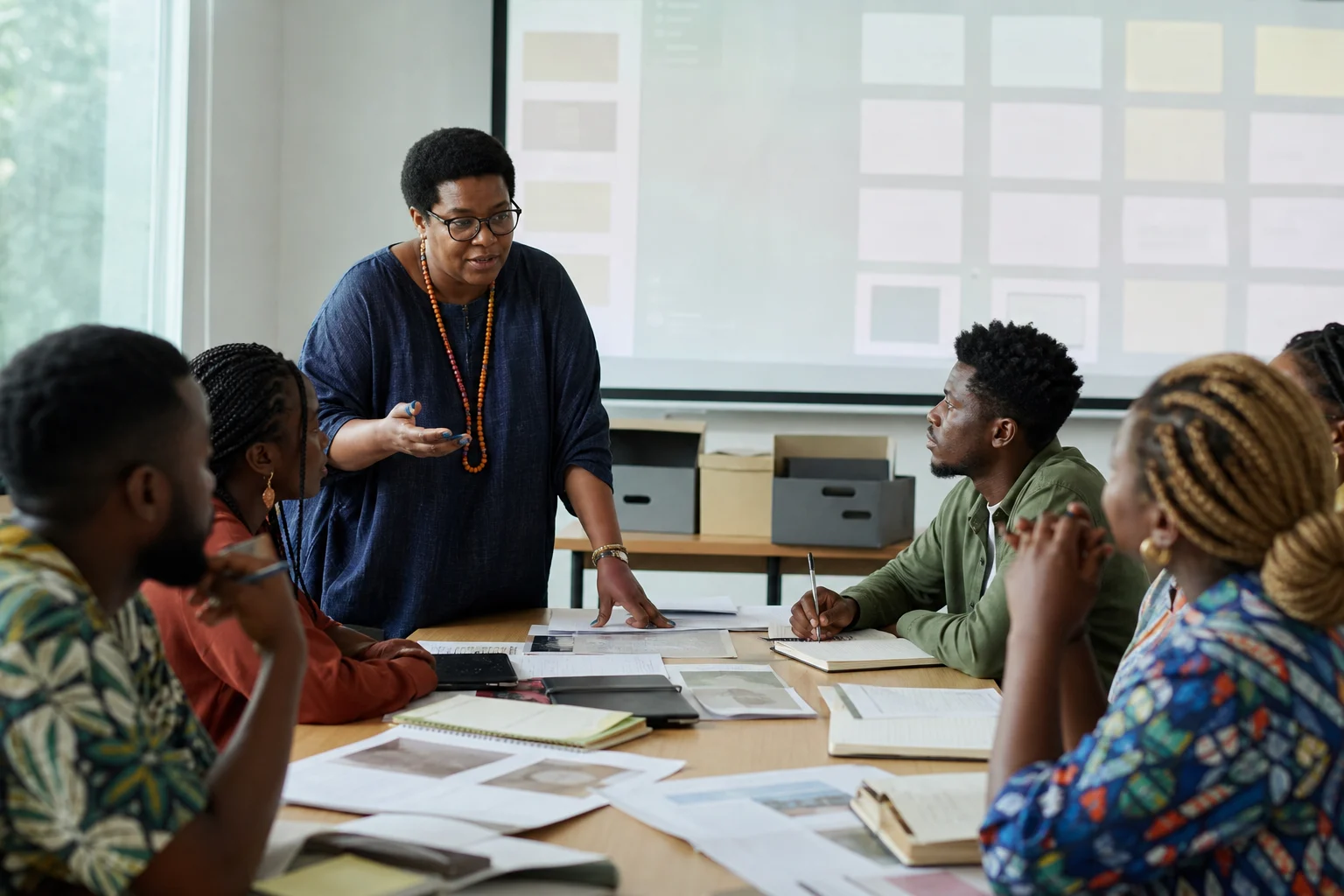 Nigerian and diaspora learners discuss cultural heritage records in a community education room